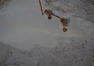 A puddle in Khardi reflects images