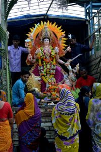 A tempo carries an idol of Goddess Durga for immersion