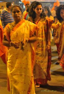 Bengali women walk in a procession durinng Durga Pooja
